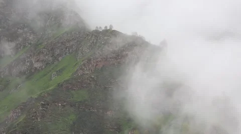 In spring the veil of mist creeping up the mountain slopes of the Caucasus Vídeos de archivo 63223640
