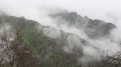 In spring the veil of mist creeping up the mountain slopes of the Caucasus Vídeo Stock 63223908
