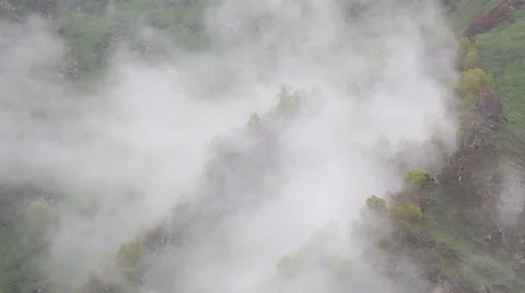 In spring the veil of mist creeping up the mountain slopes of the Caucasus Vídeos de archivo 63223985