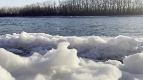 Spring walk along the snow-covered river bank Stock Footage 237683362
