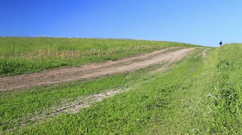 Spring walk by bicycle on a dirt road Stock Footage 62070865