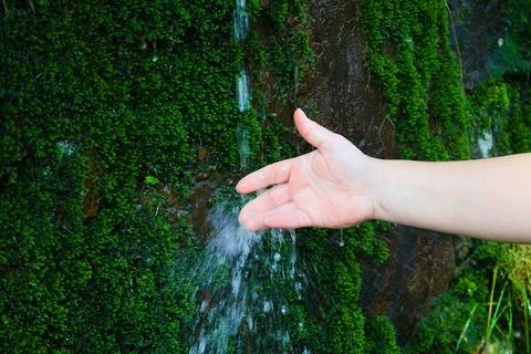 Spring water fall, hand playing with water Stock Photos