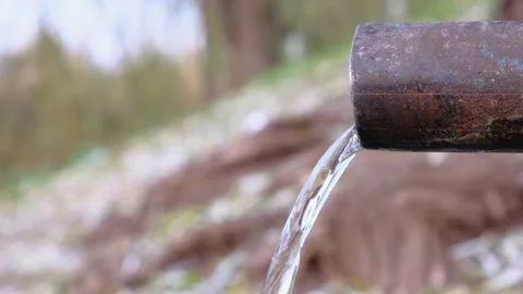 Spring water flowing from a pipe in a park at autumn day. Stock Footage 144120956
