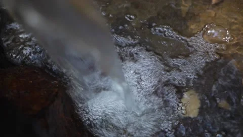 Spring water flows in a fast stream, beats against stones, splashes Stock Footage 163424949