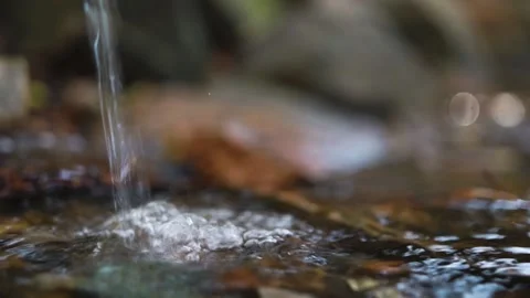 Spring water flows in a fast stream, beats against stones, splashes Stock Footage 163425552