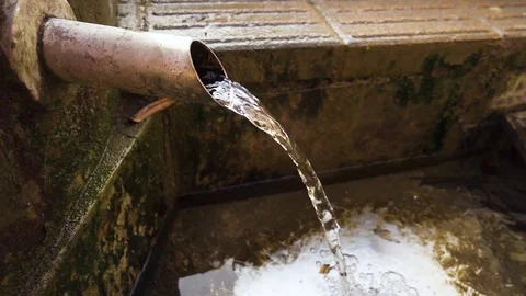 Spring water flows from the pipe Stock-Footage 82603791