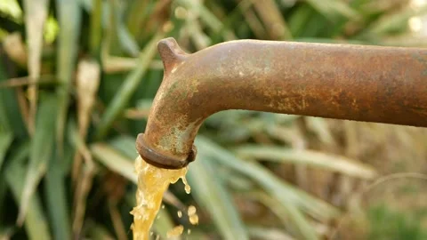 Spring water hand well pump with dirty contaminated water outlet with dark Stock Footage 157821852