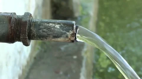Spring water pouring from a pipe Stock Footage 10817656
