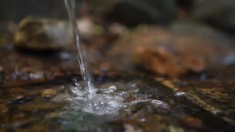 Spring water pours over lumps into a gorge on the mountain slopes Stock Footage 163425161