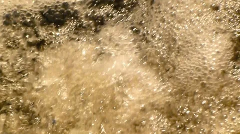 Spring water splashes and ripples as it cascades across rocks Video stock 38353444