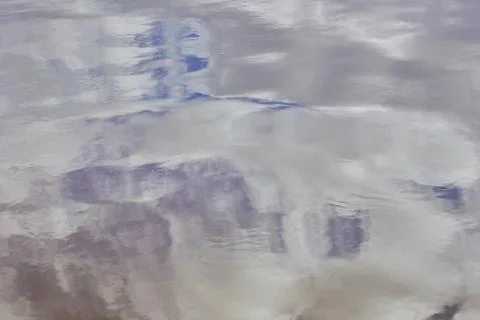 Spring water texture reflection of clouds and trees Stock-Fotos