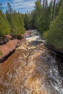 Spring Waters Rushing Down a Narrow Canyon Stockfoto's