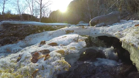 Spring waters in the stream, the snow lies in the valley, the sun is shining Stock Footage 82994968