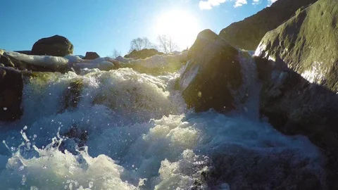 Spring waters in the stream, the snow lies in the valley, the sun is shining Stock Footage 109584624