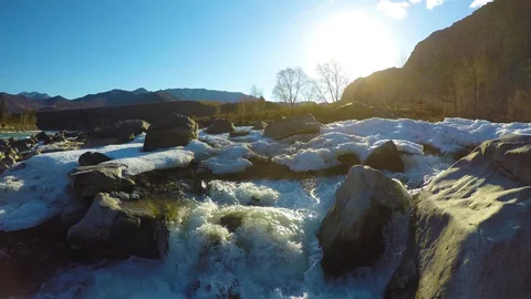 Spring waters in the stream, the snow lies in the valley, the sun is shining Stock Footage 109584721