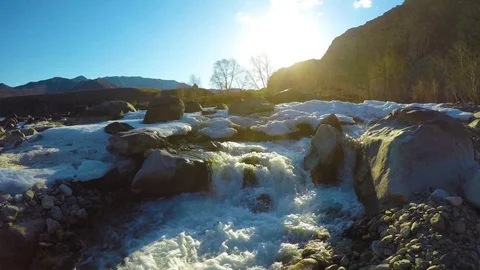 Spring waters in the stream, the snow lies in the valley, the sun is shining Stock Footage 109584755
