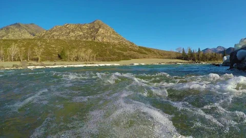 Spring waters in the stream, the snow lies in the valley, the sun is shining Stock Footage 109584838