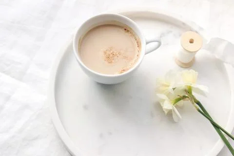 Spring wedding still life composition. Closeup of cup of coffe with milk, silk Foto stock