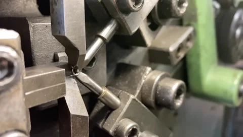 Spring winding on the machine. Manufacturing of a spring in production. Video stock 295874431