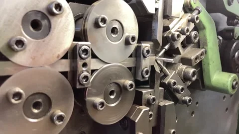 Spring winding on the machine. Manufacturing of a spring in production. Video stock 295874434