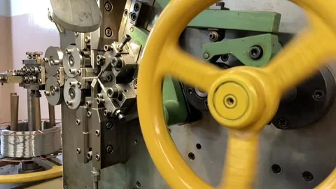 Spring winding on the machine. Manufacturing of a spring in production. Video stock 295874482