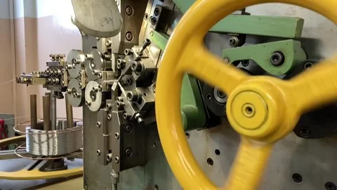 Spring winding on the machine. Manufacturing of a spring in production. Video stock 295874498