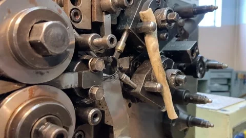 Spring winding on the machine. Manufacturing of a spring in production. Video stock 295874522