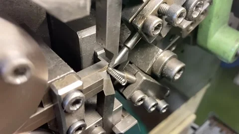 Spring winding on the machine. Manufacturing of a spring in production. Video stock 295874536