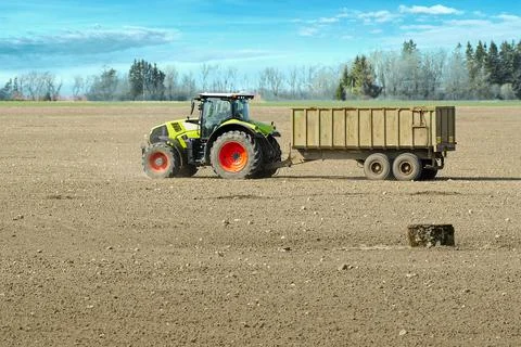 Spring work at farm. Farmer in tractor preparing the field for sowing. Farmer Stock Photos