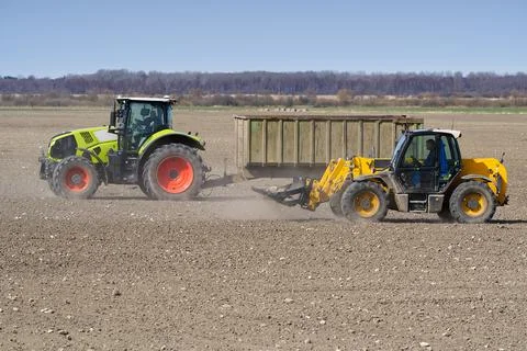 Spring work at farm. Farmer in tractor preparing the field for sowing. Farmer Stock Photos