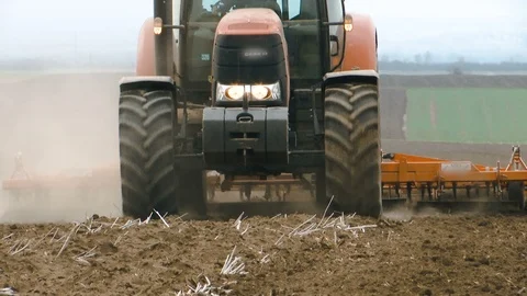 Spring work with a tractor in the field Stock Footage 104965194