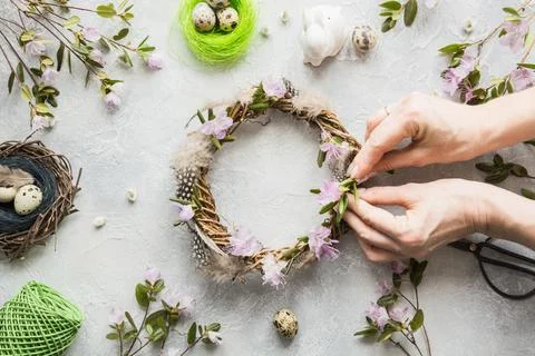 Spring wreath with flowers on light background. Flat lay. Top view. Decor han Stock Photos