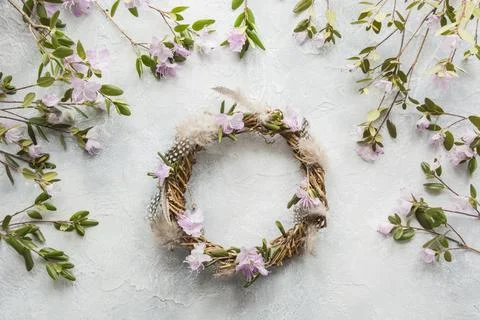 Spring wreath with flowers on light. Creative flat lay. Decor handmade. Stock Photos
