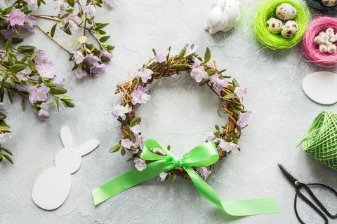 Spring wreath with flowers on light. Creative flat lay. Decor handmade. Stock Photos