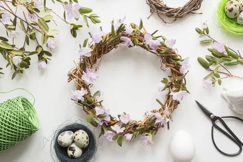 Spring wreath with flowers on light. Creative flat lay. Decor handmade. Stock Photos