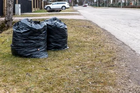 Spring Yard Cleanup With Black Garbage Bags Filled With Leaves and Branches Stock Photos