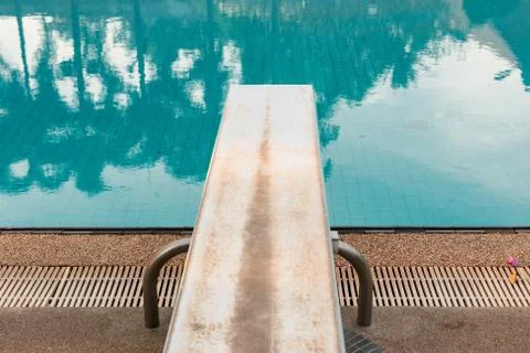 Springboard to dive at swimmingpool Stock Photos