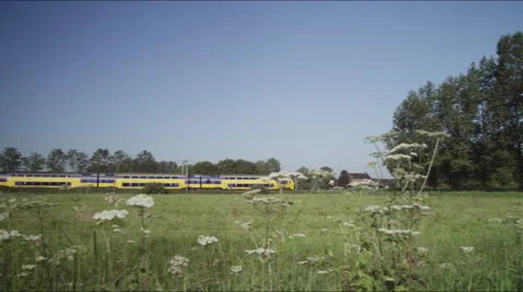 Springday with green fields and train in countryside Stock Footage 42727385