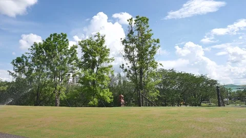 Springer watering the grass around Stock Footage 76442791