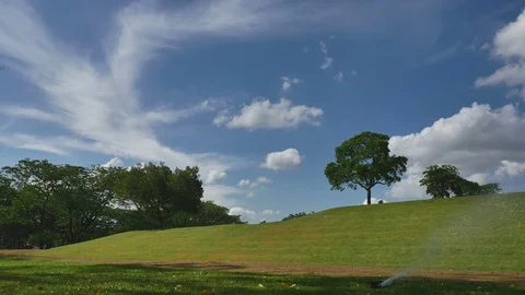 Springer watering the grass around Stock Footage 76443718