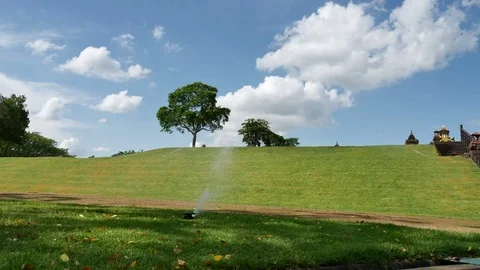 Springer watering the grass around Stock Footage 76450803