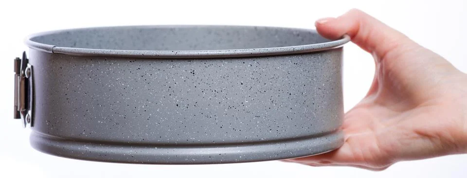 Springform baking pan in hand Stock Photos