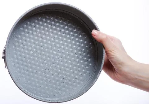 Springform baking pan in hand Stock Photos