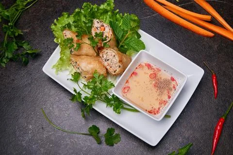 Springrolls on a dark table top view. Pan-asian dish cuisine Stock Photos