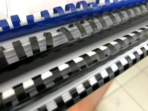 Springs Used for Binding Papers Into Reports and Catalogs in an Office Settin Stock Photos