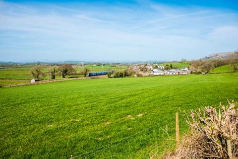 Springtime fields with hedges, trees beautiful blue sky Stock Photos