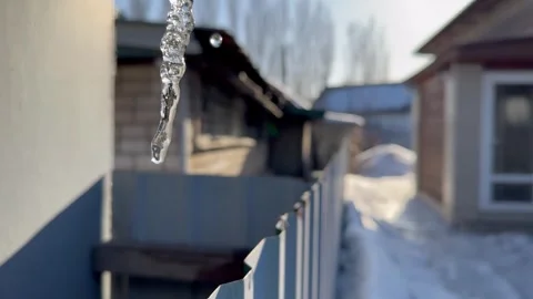 Springtime, ice melting in the sun, water dripping from icicles Stock Footage 270246539