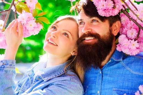 Springtime. Spring sakura bloom. Happy couple in spring garden. Tourist famil Stock Photos