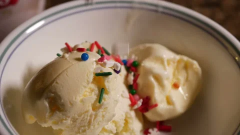 Sprinkals falling in slow motion on vanilla ice cream in white bowl ready to eat Stock Footage 150919056