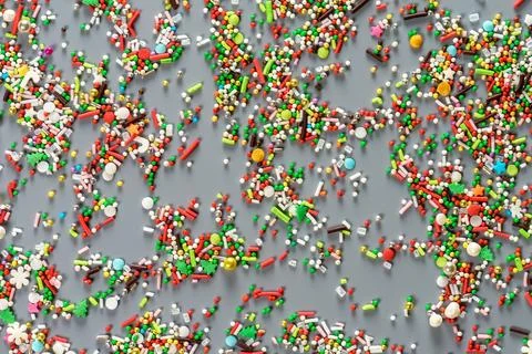 Sprinking from sweets scattered in the background. Stock Photos